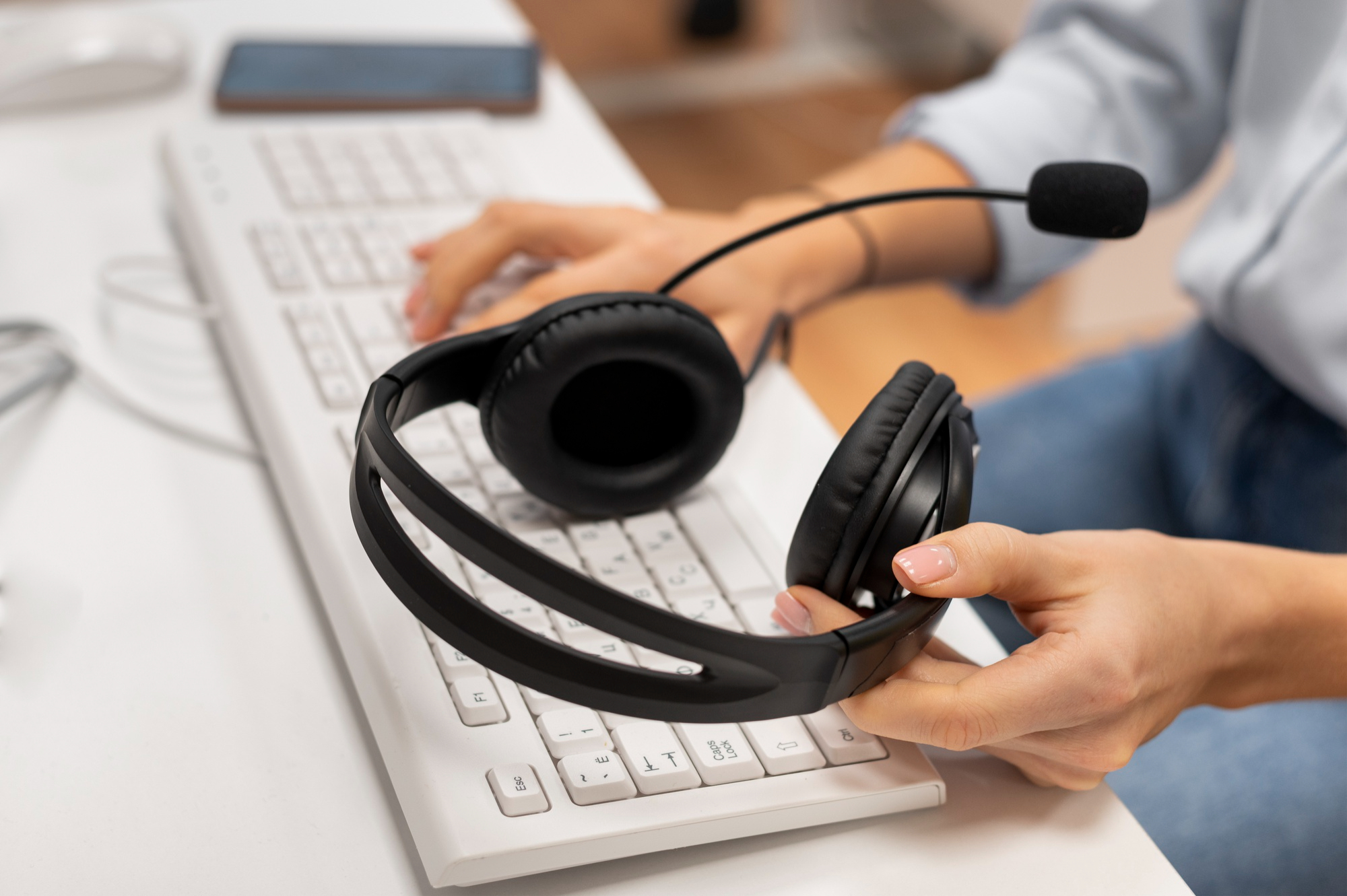 woman-working-call-center-holding-pair-headphones